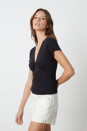 A model wearing a t-shirt and Velvet by Graham & Spencer Natalie Rolled Hem Shorts.