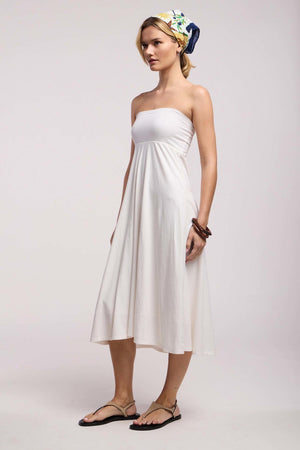 Woman in profile wearing the LUELLA SKIRT by Velvet by Graham & Spencer, styled with flat sandals, a printed headscarf, and a chunky bracelet against a plain background.