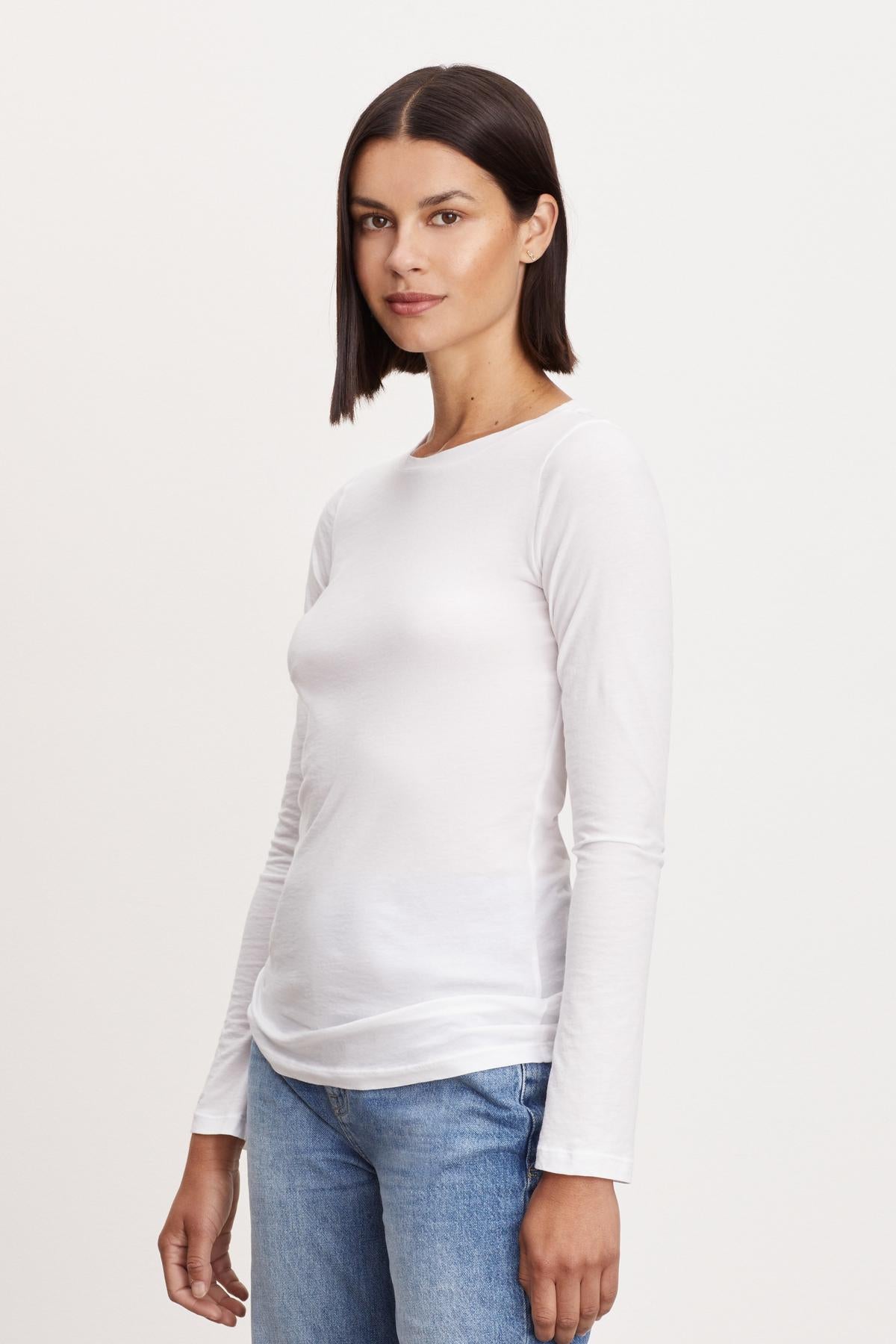 A woman wearing a ZOFINA GAUZY WHISPER FITTED CREW NECK TEE by Velvet by Graham & Spencer.-26839199645889