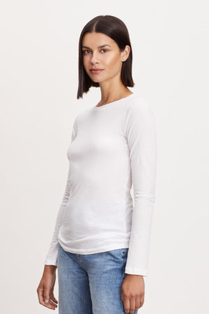 A woman wearing a ZOFINA GAUZY WHISPER FITTED CREW NECK TEE by Velvet by Graham & Spencer.