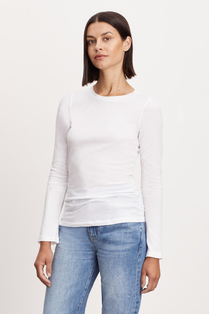 The model is wearing a Velvet by Graham & Spencer ZOFINA GAUZY WHISPER FITTED CREW NECK TEE.