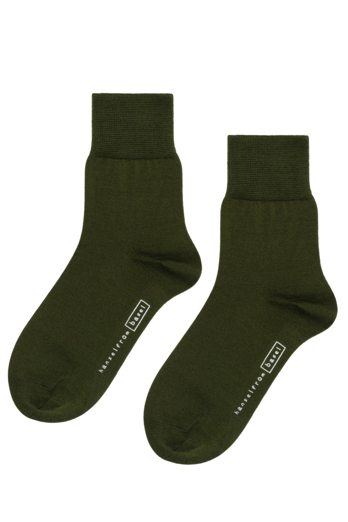   The TROUSER CREW SOCKS BY HANSEL FROM BASEL are dark green ankle socks made from mercerized cotton, featuring ribbed cuffs and a white logo with lettering on the sole by Hansel From Basel. 