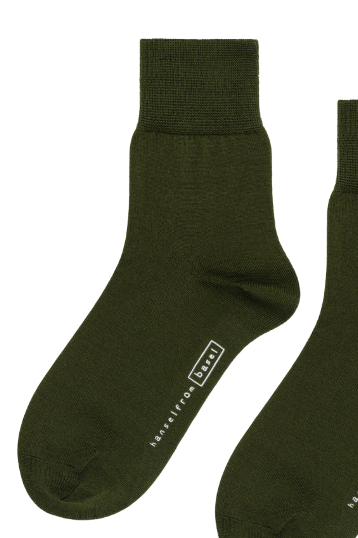   Upgrade your collection with Hansel From Basel's TROUSER CREW SOCKS, featuring two dark green socks made from luxurious mercerized cotton, a ribbed cuff, and an inscription on one sock for added style and comfort. 