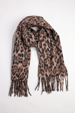The LEOPARD SCARF by Velvet by Graham & Spencer features a brown and black leopard print and fringed ends, displayed flat on a white background.
