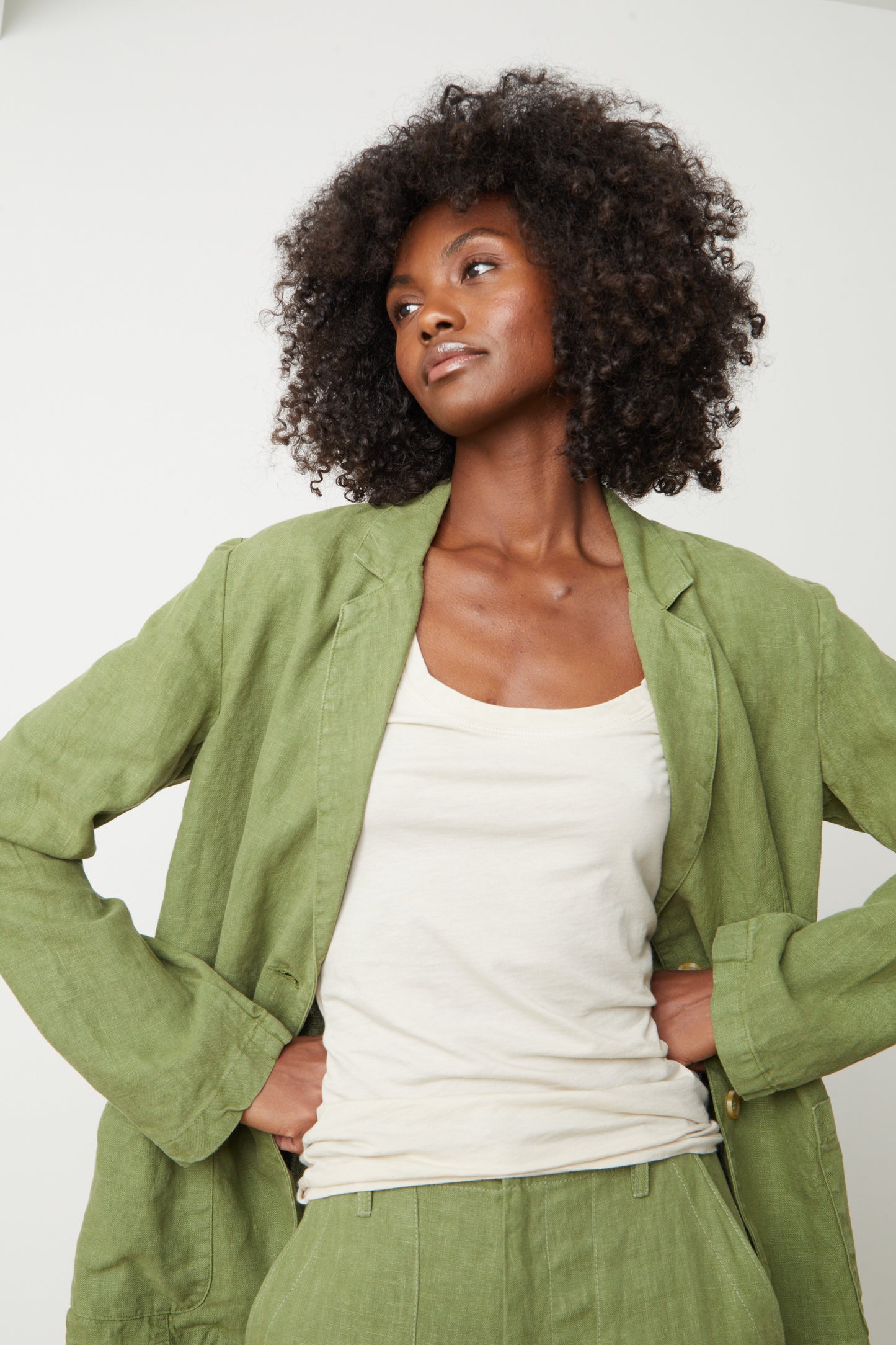 A woman wearing a Velvet by Graham & Spencer Cassie Heavy Linen blazer and pants exudes cool-girl style.-35649991311553