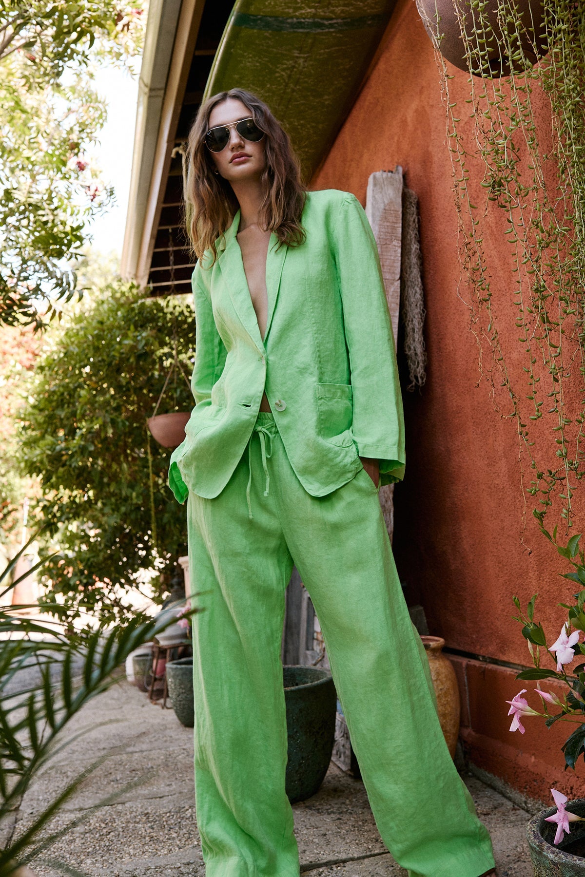   a woman wearing Velvet by Graham & Spencer's GWYNETH HEAVY LINEN PANT suit and sunglasses. 