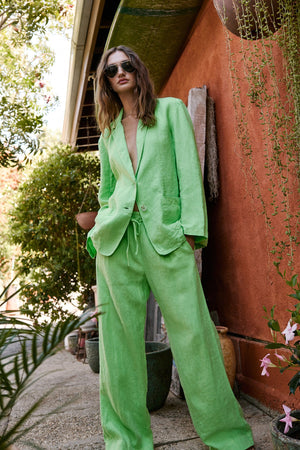 a woman wearing Velvet by Graham & Spencer's GWYNETH HEAVY LINEN PANT suit and sunglasses.