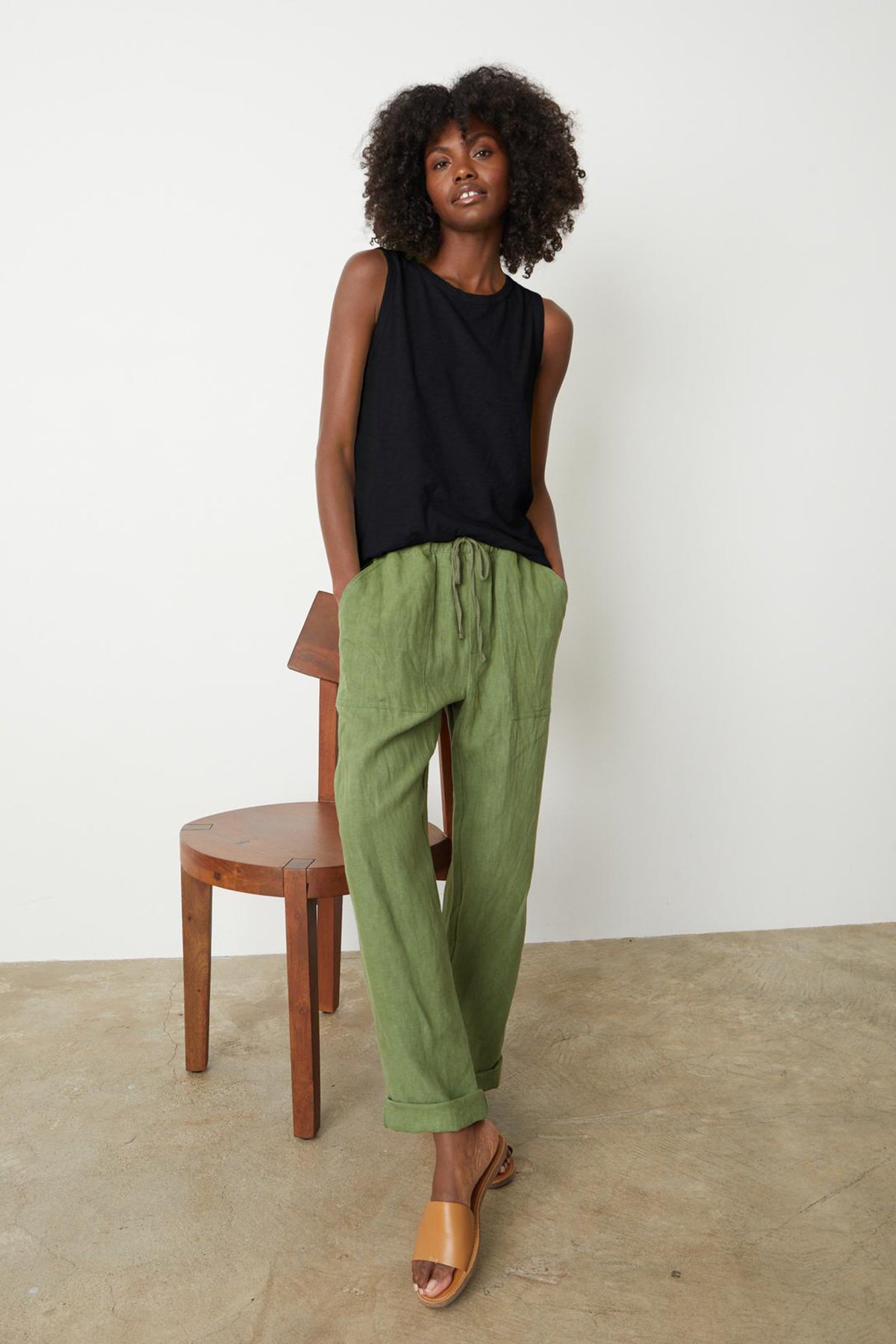 The model is wearing a black Taurus tank and Velvet by Graham & Spencer CINDY HEAVY LINEN PANT.-26671451865281