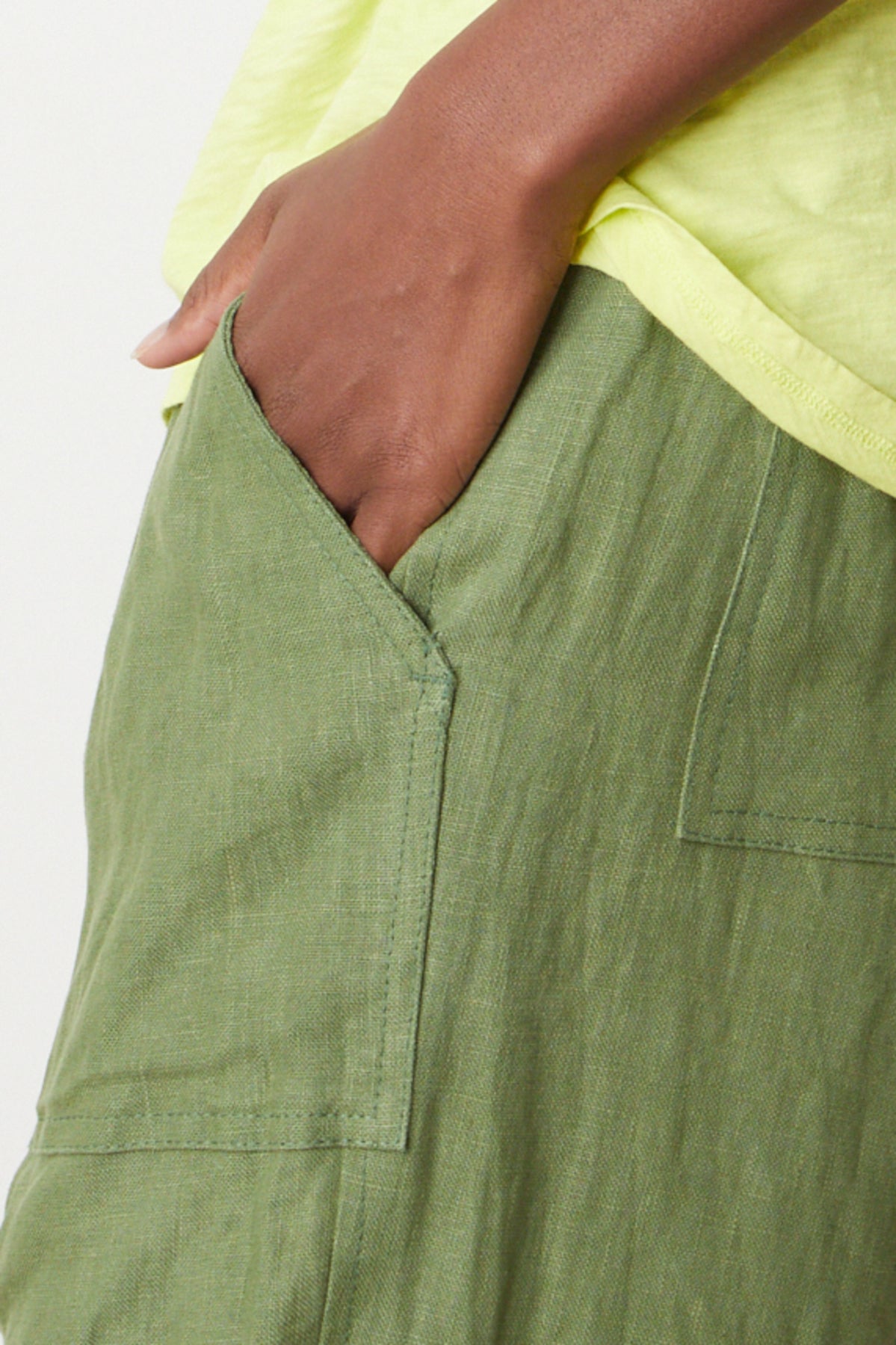   CINDY HEAVY LINEN PANT by Velvet by Graham & Spencer in basil green close up of hand in pocket 