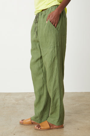 A woman wearing Velvet by Graham & Spencer's CINDY HEAVY LINEN PANT and a yellow t - shirt.