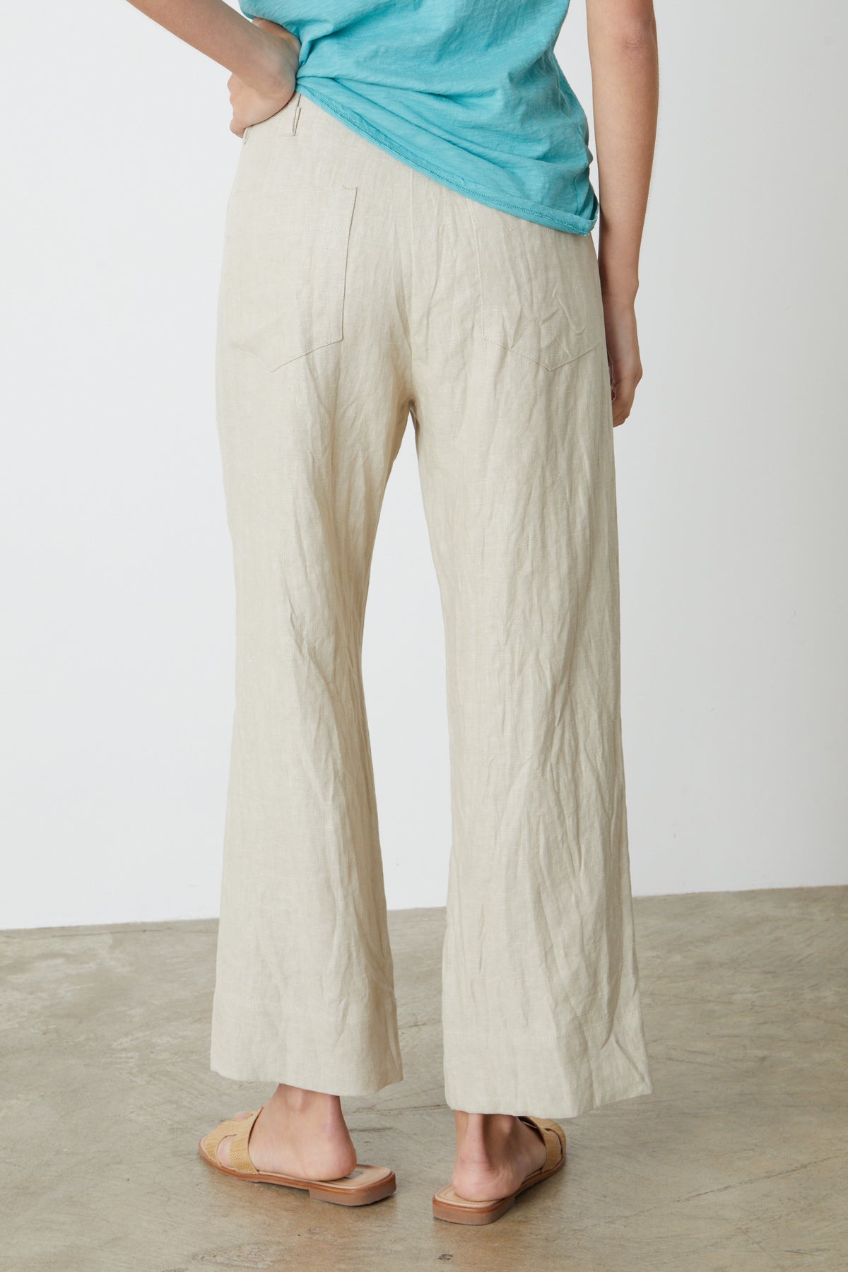 The back view of a woman wearing Velvet by Graham & Spencer's DRU HEAVY LINEN PANT.-26544378839233