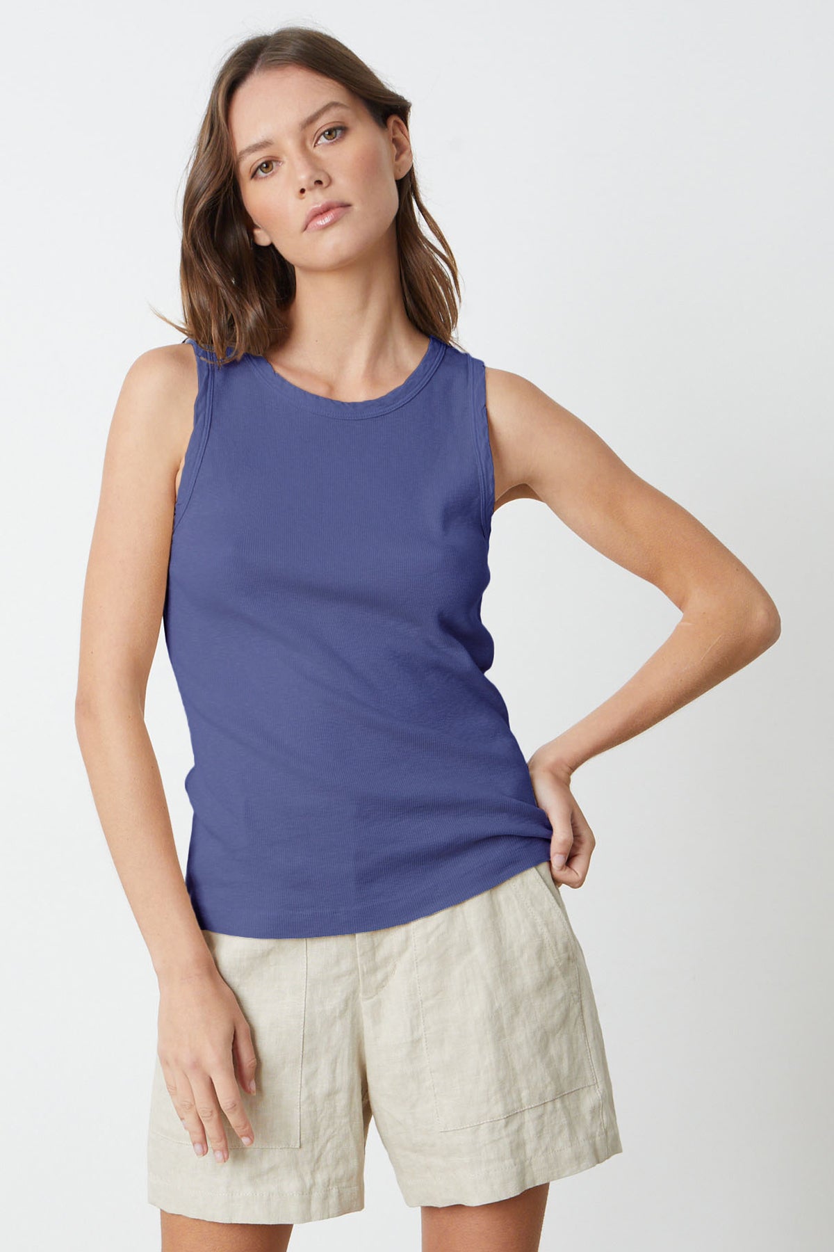 a woman wearing a Velvet by Graham & Spencer MAXIE RIBBED TANK TOP in cavern blue and tan shorts.-35206385860801