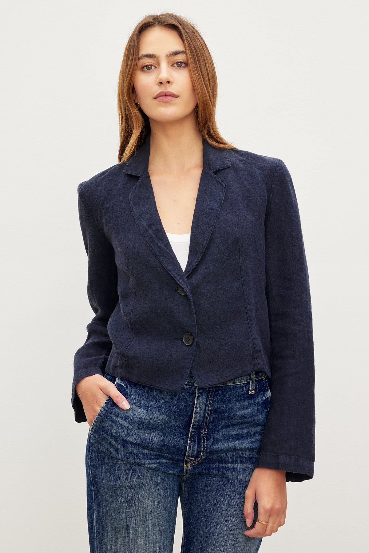 The model is wearing a blue Velvet by Graham & Spencer FINLEY HEAVY LINEN CROPPED BLAZER and jeans.-35982562623681