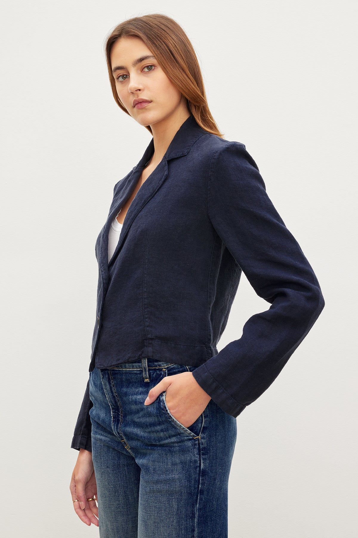   The model is wearing a Velvet by Graham & Spencer FINLEY HEAVY LINEN CROPPED BLAZER and jeans. 