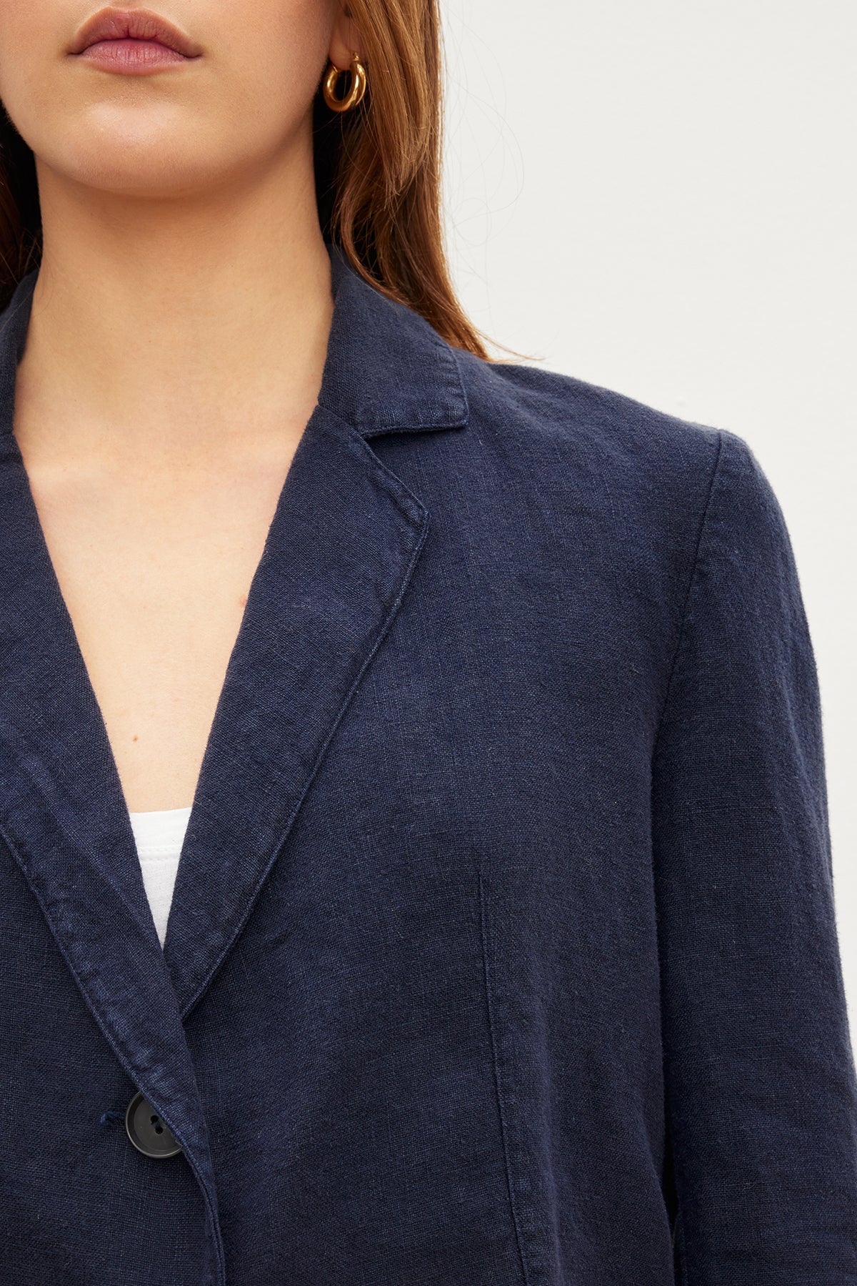   A woman wearing a Velvet by Graham & Spencer FINLEY HEAVY LINEN CROPPED BLAZER. 