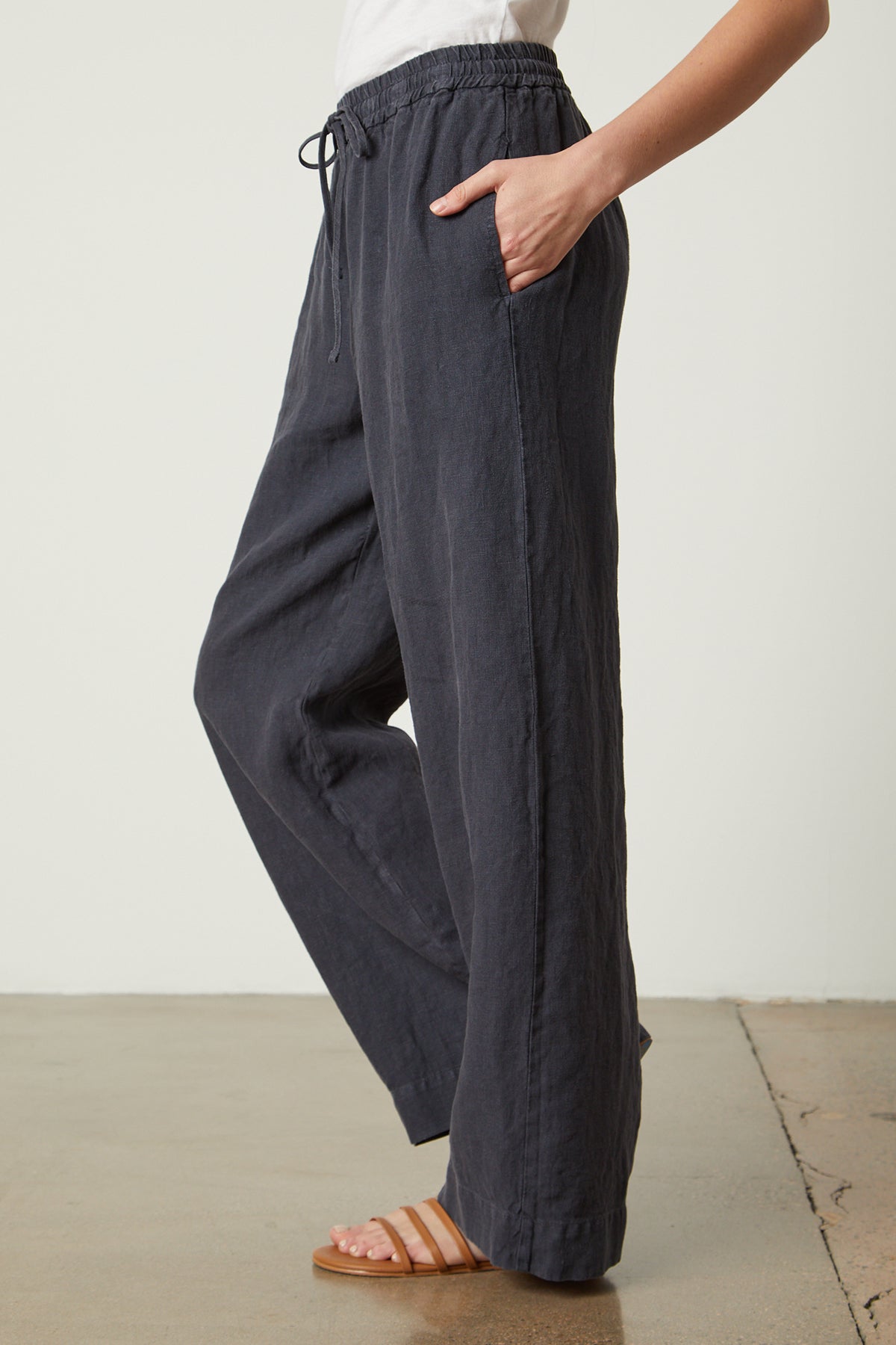 a woman wearing Velvet by Graham & Spencer GWYNETH HEAVY LINEN PANT and a white t - shirt.-35954253529281
