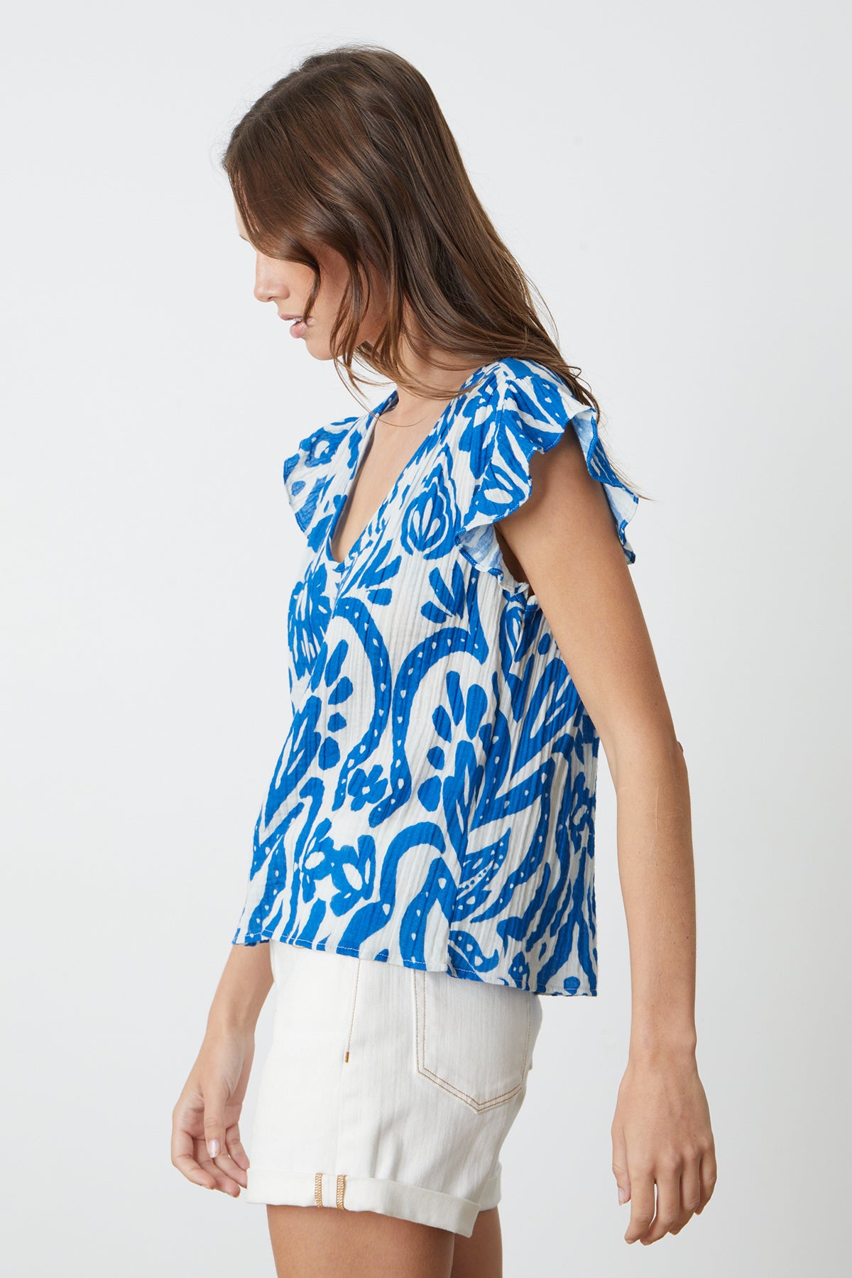   The model is wearing an ALEAH PRINTED COTTON GAUZE top by Velvet by Graham & Spencer. 