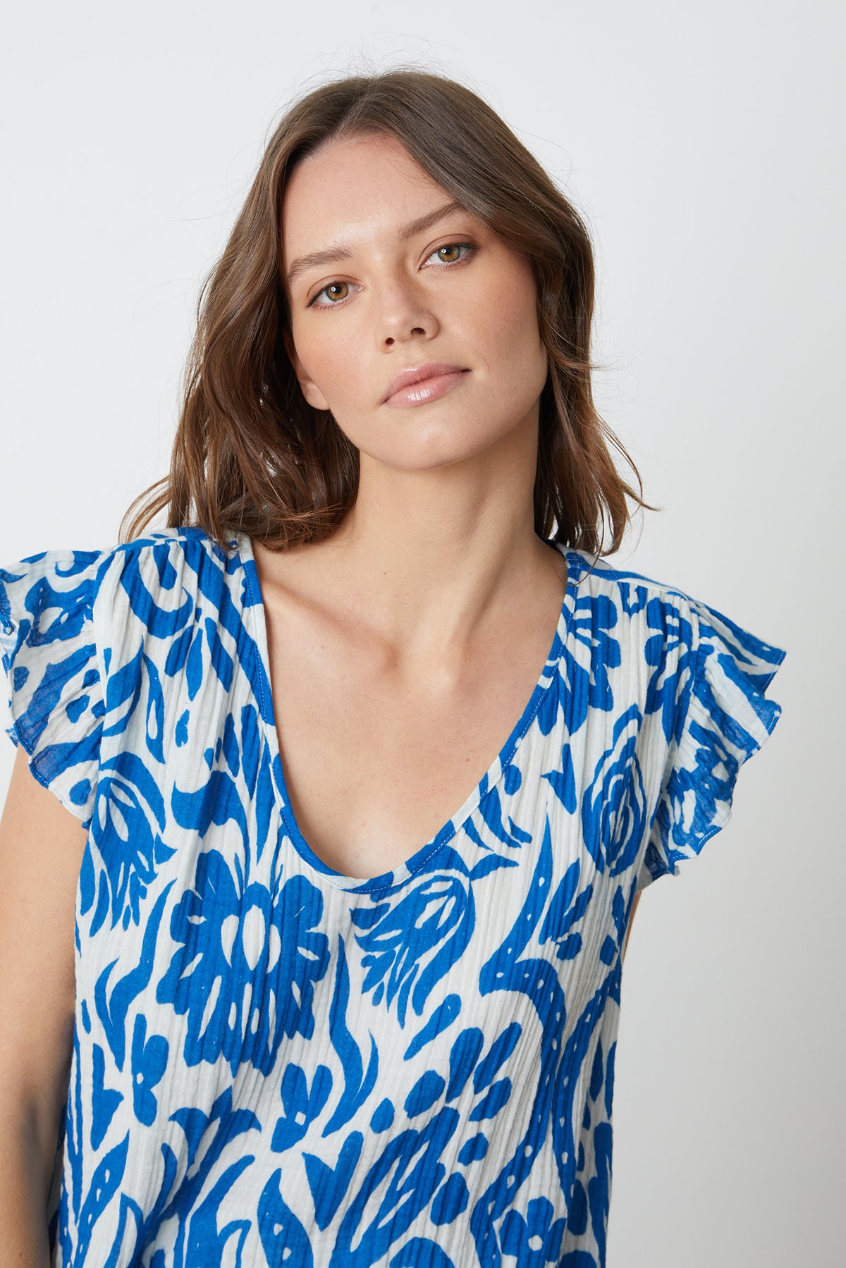   a model wearing an ALEAH PRINTED COTTON GAUZE top by Velvet by Graham & Spencer. 