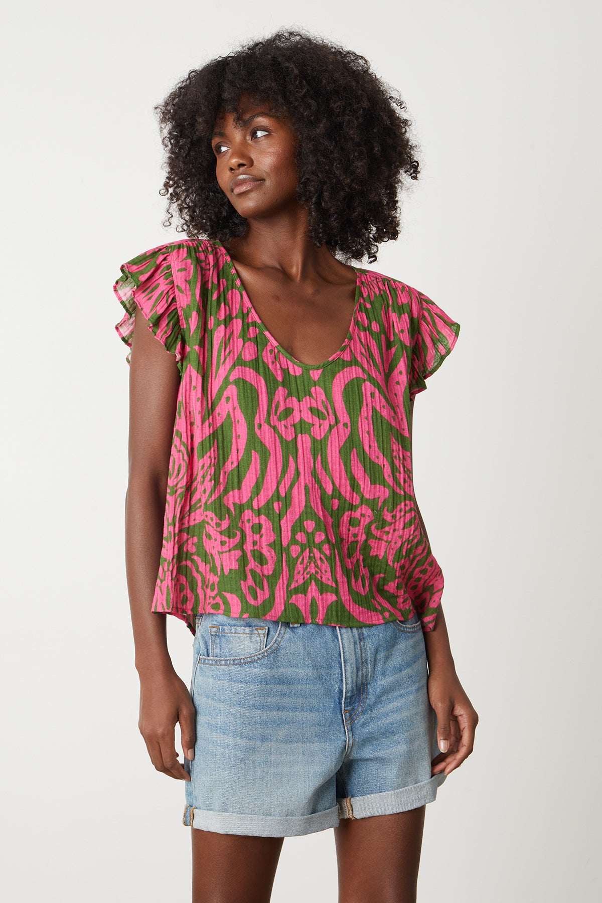   The model is wearing a Velvet by Graham & Spencer ALEAH PRINTED COTTON GAUZE TOP with ruffles. 