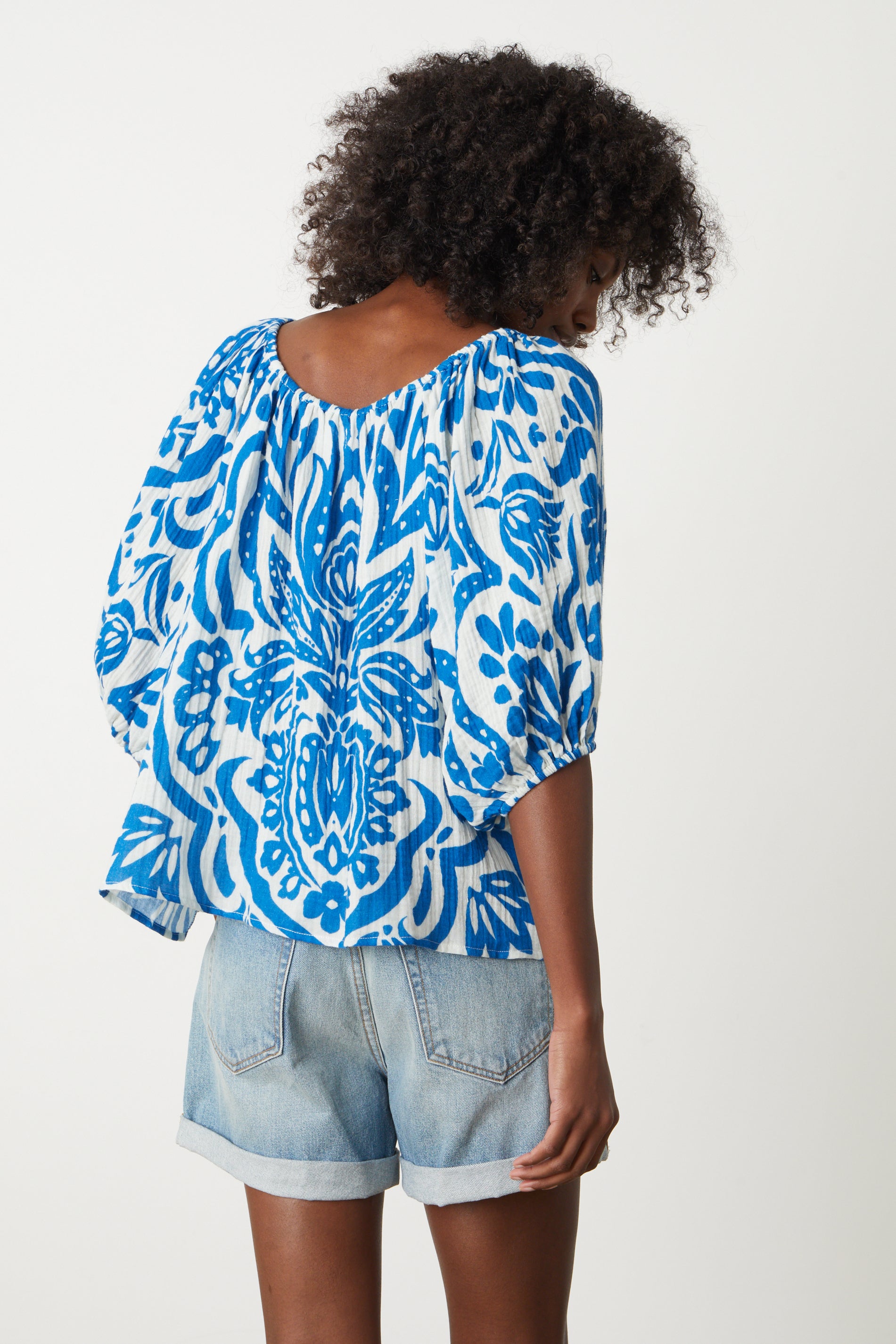   the back view of a woman wearing the Velvet by Graham & Spencer CANDICE PRINTED COTTON GAUZE TOP. 