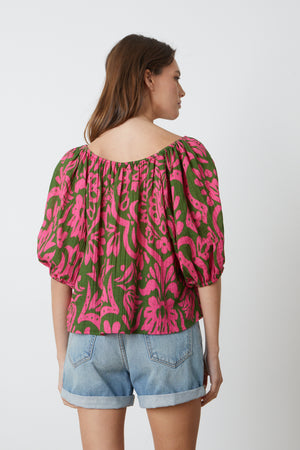 The back view of a woman wearing a CANDICE PRINTED COTTON GAUZE TOP by Velvet by Graham & Spencer.