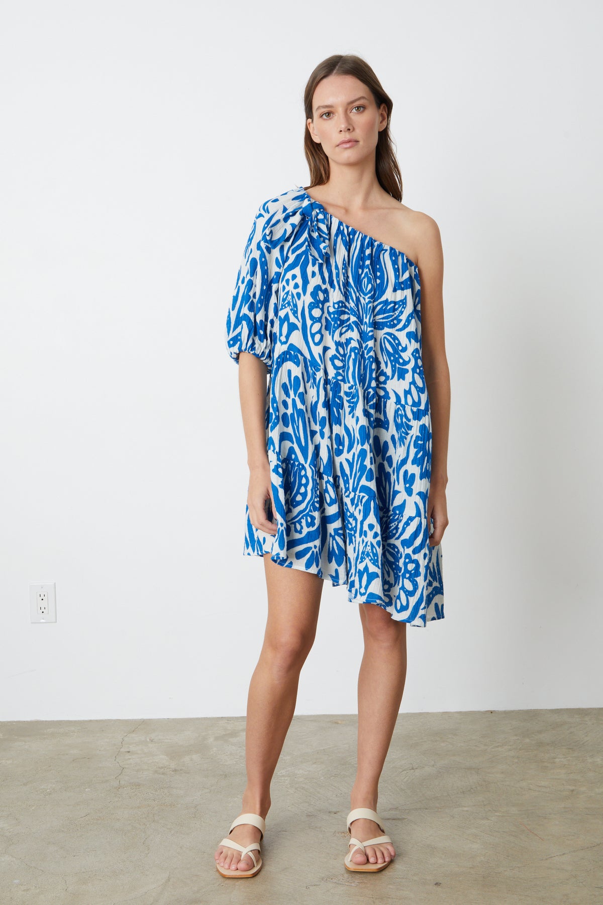 A model wearing the Velvet by Graham & Spencer Gretchen Printed One Shoulder Dress.-26774928261313