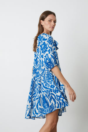 A model wearing the Velvet by Graham & Spencer Gretchen Printed One Shoulder Dress.