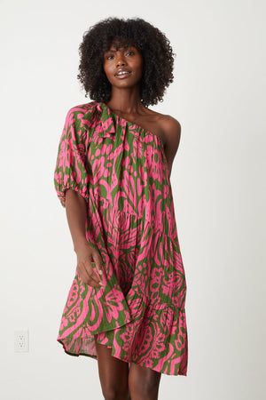 a woman wearing the Velvet by Graham & Spencer GRETCHEN PRINTED ONE SHOULDER DRESS.