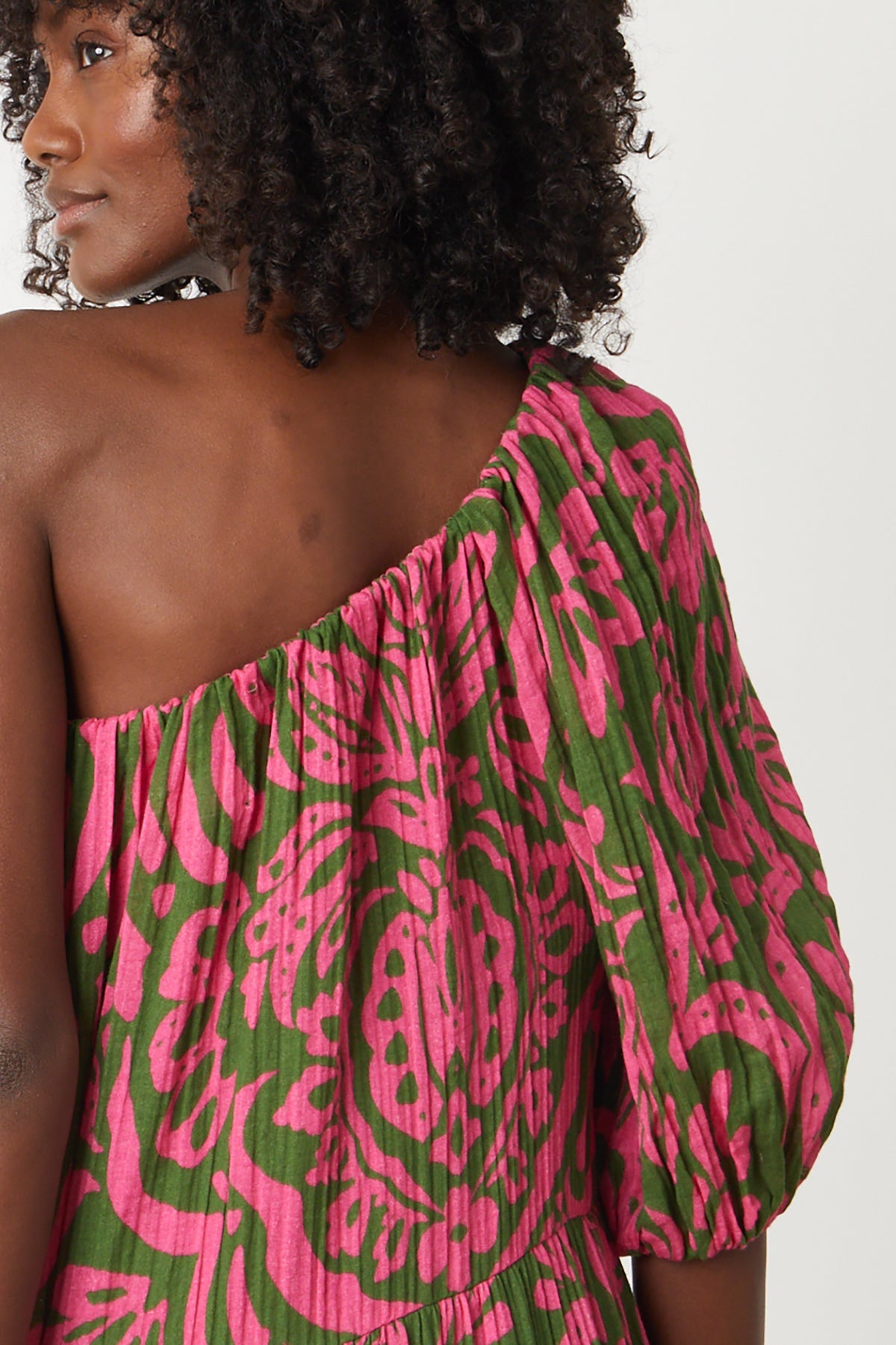 the back view of a woman wearing a Velvet by Graham & Spencer Gretchen printed one shoulder dress.-26801042194625