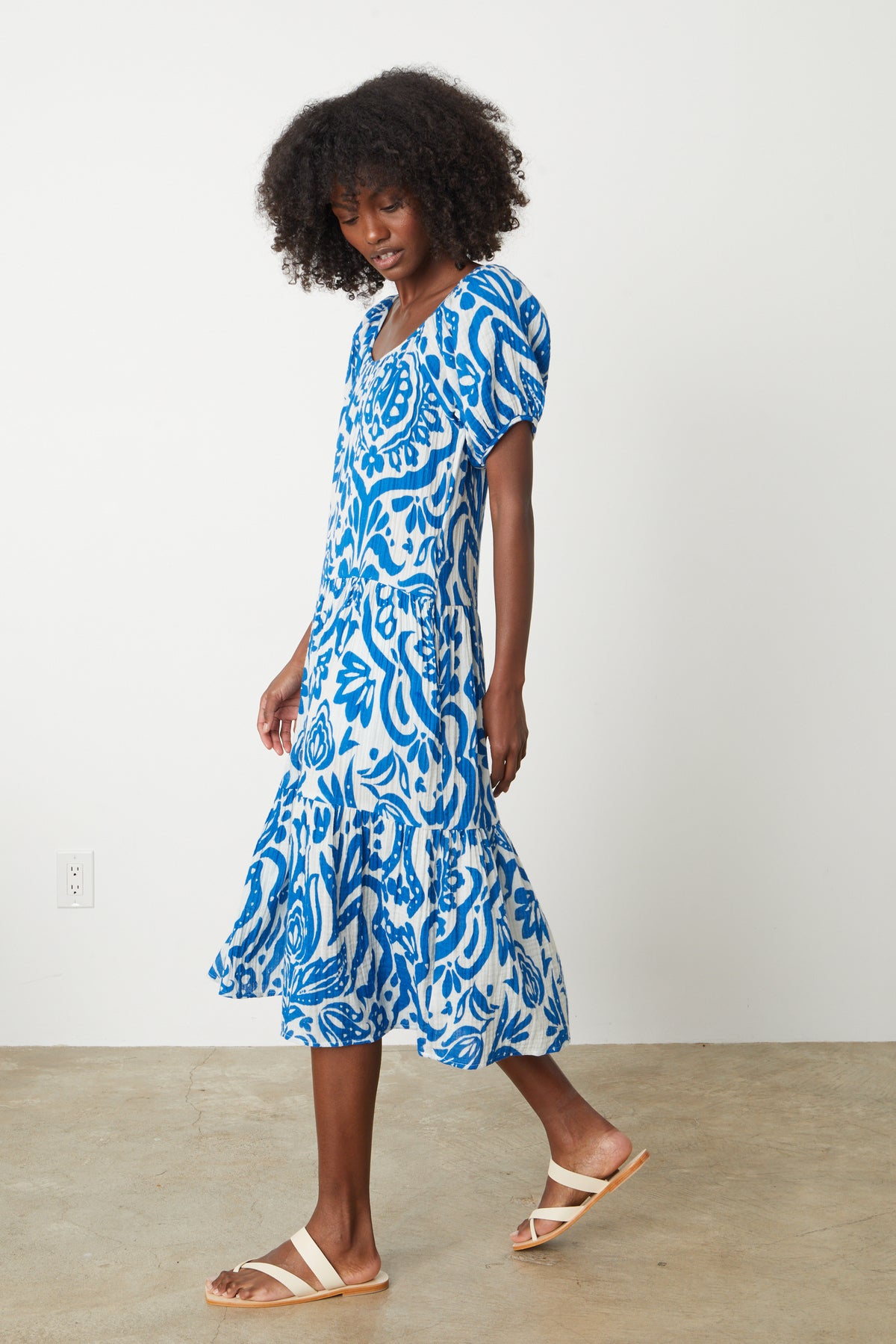   A woman wearing a MADILYN PRINTED COTTON GAUZE MIDI DRESS with a splashy print by Velvet by Graham & Spencer. 