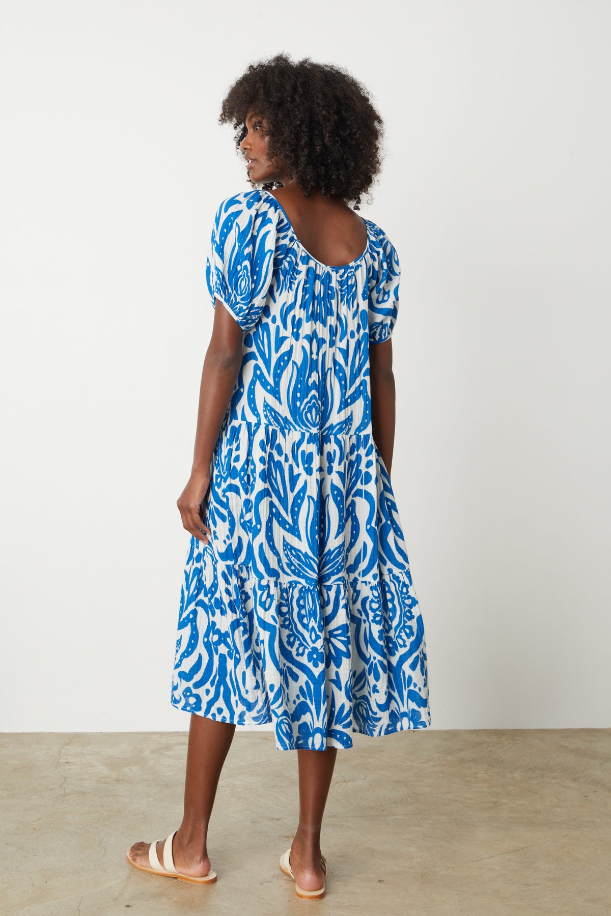 The back view of a woman wearing a Velvet by Graham & Spencer Madilyn Printed Cotton Gauze Midi Dress.-35205229052097