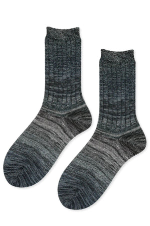 The COSMIC SPACE DYE MEN'S CREW SOCKS BY HANSEL FROM BASEL are dark grey ribbed crew socks with a gradient pattern and textured knit design, shown laid flat on a white background.