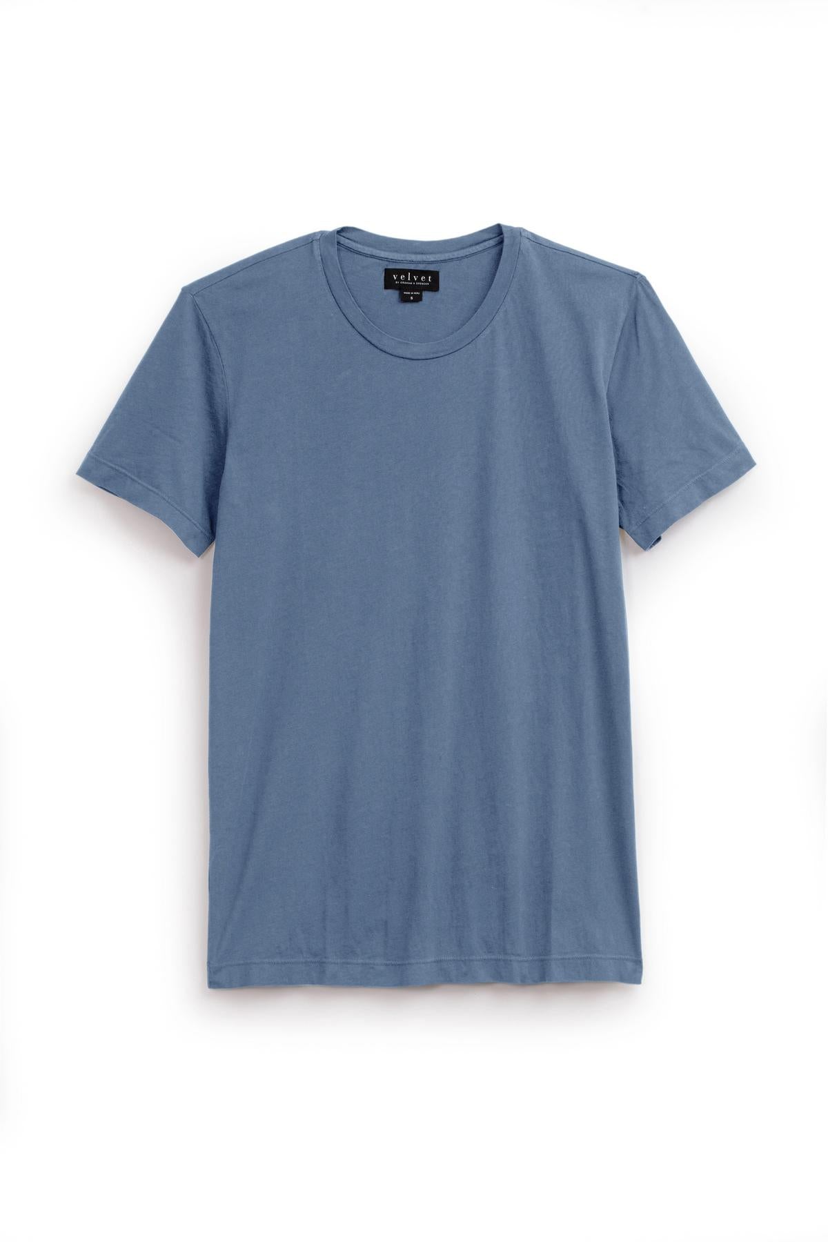   The HOWARD TEE by Velvet by Graham & Spencer is a plain blue short-sleeved T-shirt with a round neckline made from Pima cotton jersey, displayed on a white background. 