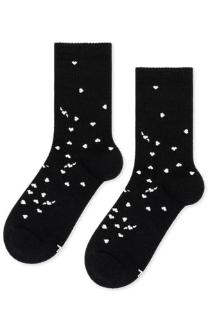 The IMI Athletic Wool Crew Socks by Hansel From Basel are black crew socks featuring small white heart patterns scattered across the fabric.