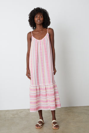 A model wearing the Velvet by Graham & Spencer LEXY JACQUARD DRESS, a pink and white striped jacquard print dress.