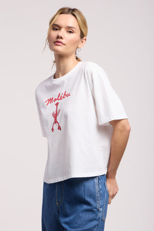 A person wears the SAMMY TEE by Velvet by Graham & Spencer, a relaxed white t-shirt featuring 