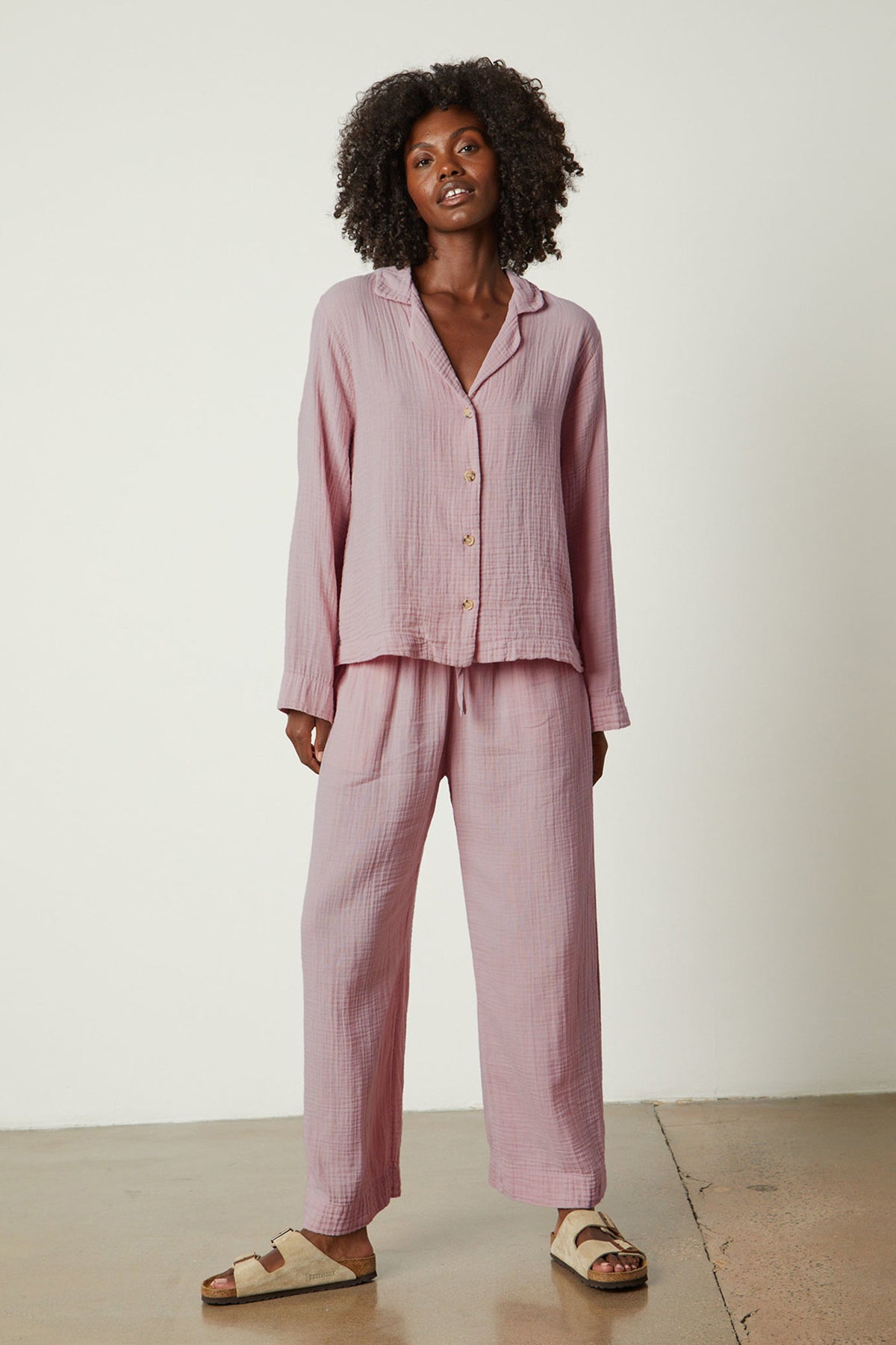   The model is wearing a pink Jenny Graham Home pajama shirt set. 