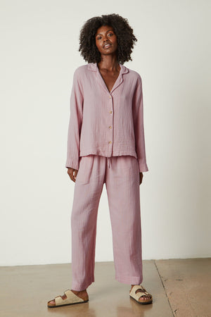 The model is wearing a pink Jenny Graham Home pajama shirt set.