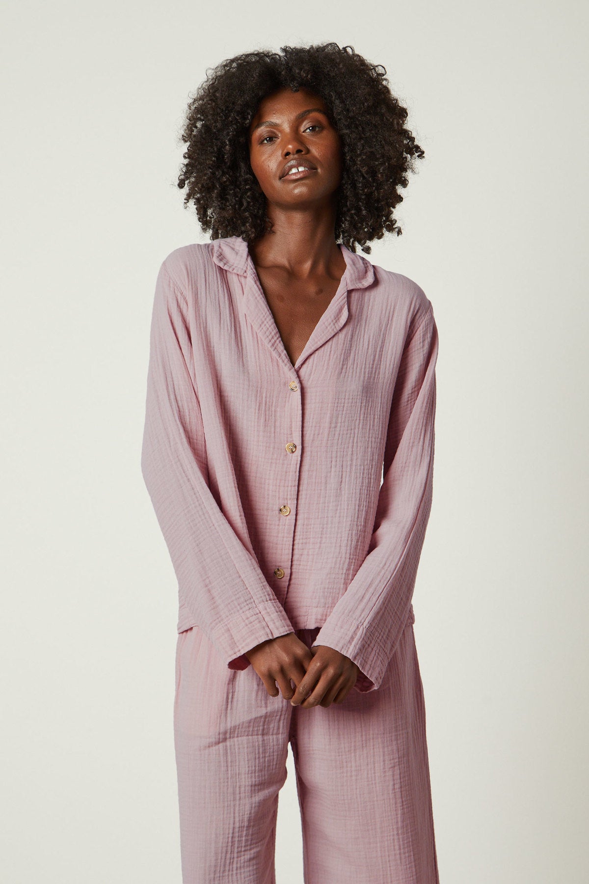   The model is wearing a pink Jenny Graham Home pajama shirt set. 