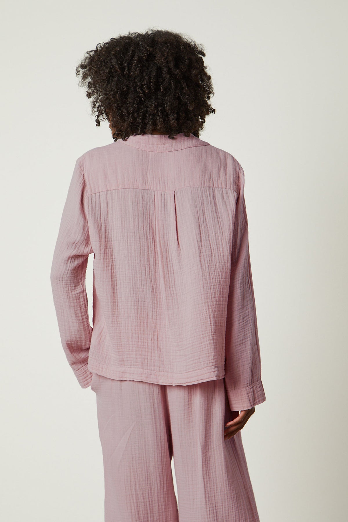  the back view of a woman in Jenny Graham Home's pink PAJAMA SHIRT. 