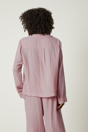 the back view of a woman in Jenny Graham Home's pink PAJAMA SHIRT.