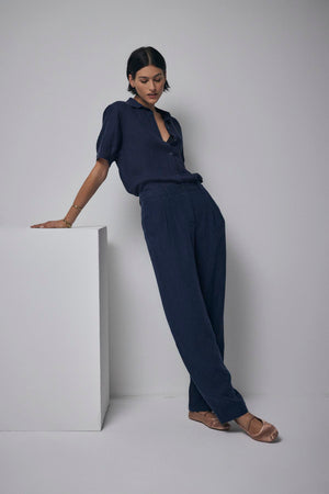 A woman is posing for a photo in Velvet by Jenny Graham's Pomona Pant in navy.