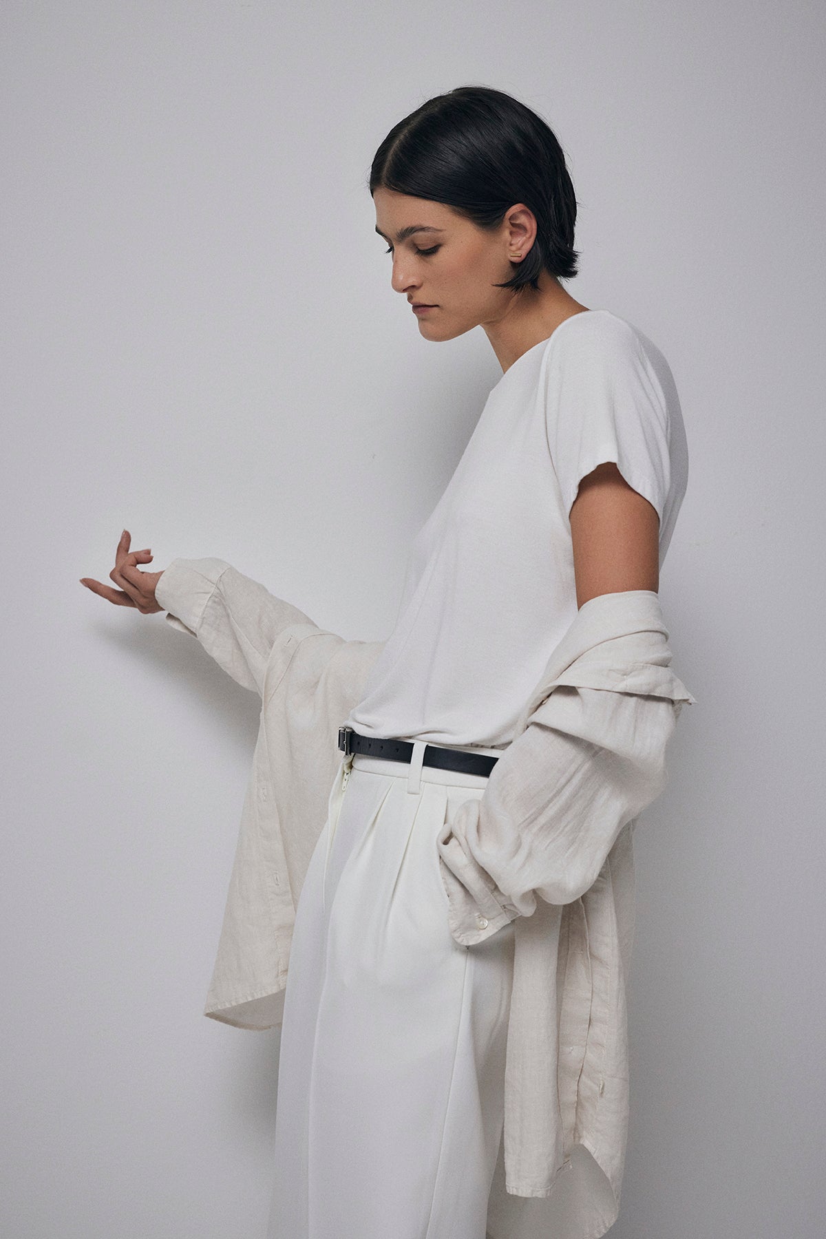   A woman wearing white pants and a Velvet by Jenny Graham SOLANA TEE. 