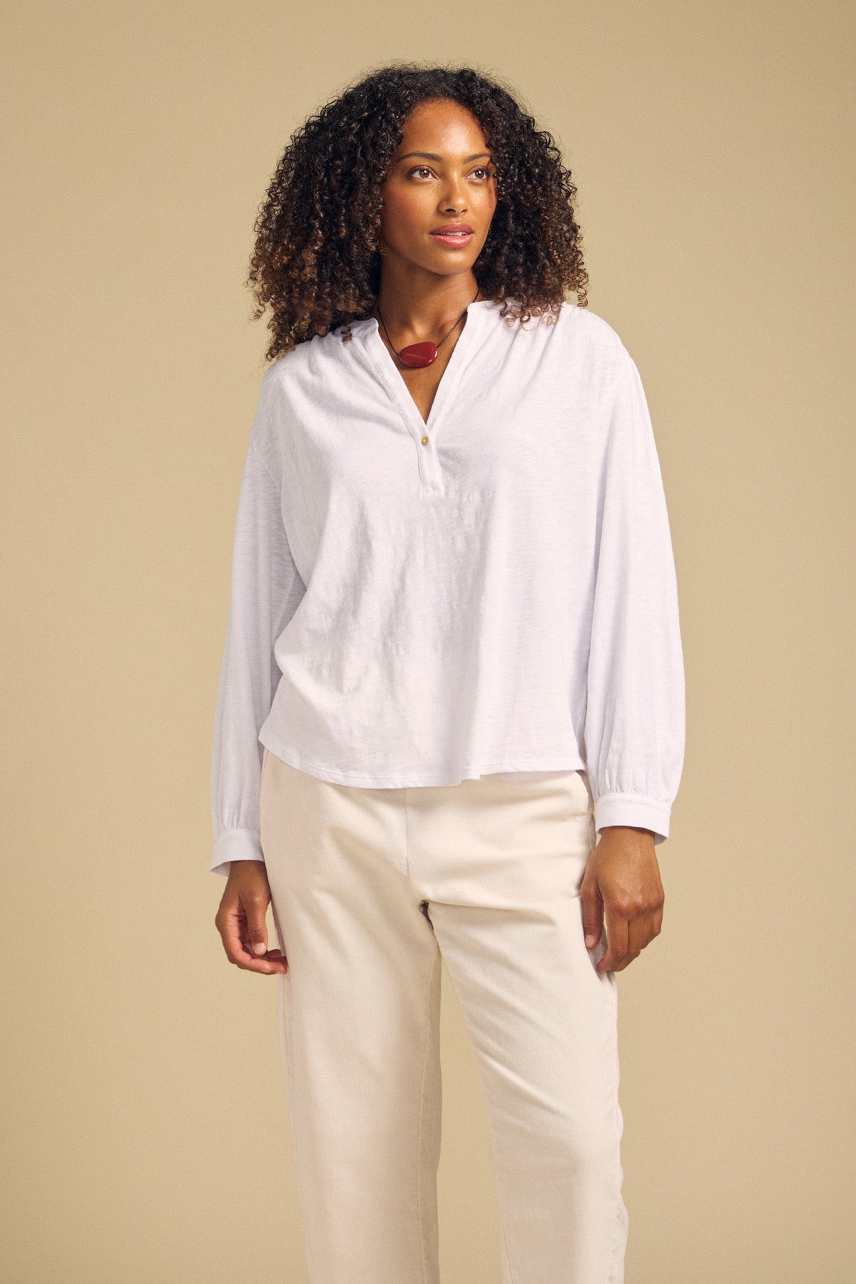 Front view of the white KNOX cotton slub three-quarter-sleeve split-neck tee on a model with cream pants against a beige background-41929870147777