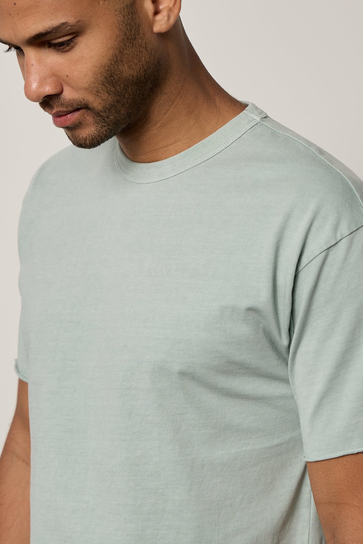 Man facing front wearing Beau Tee in mint green front detail showing raw-edge cuff-26468396105921