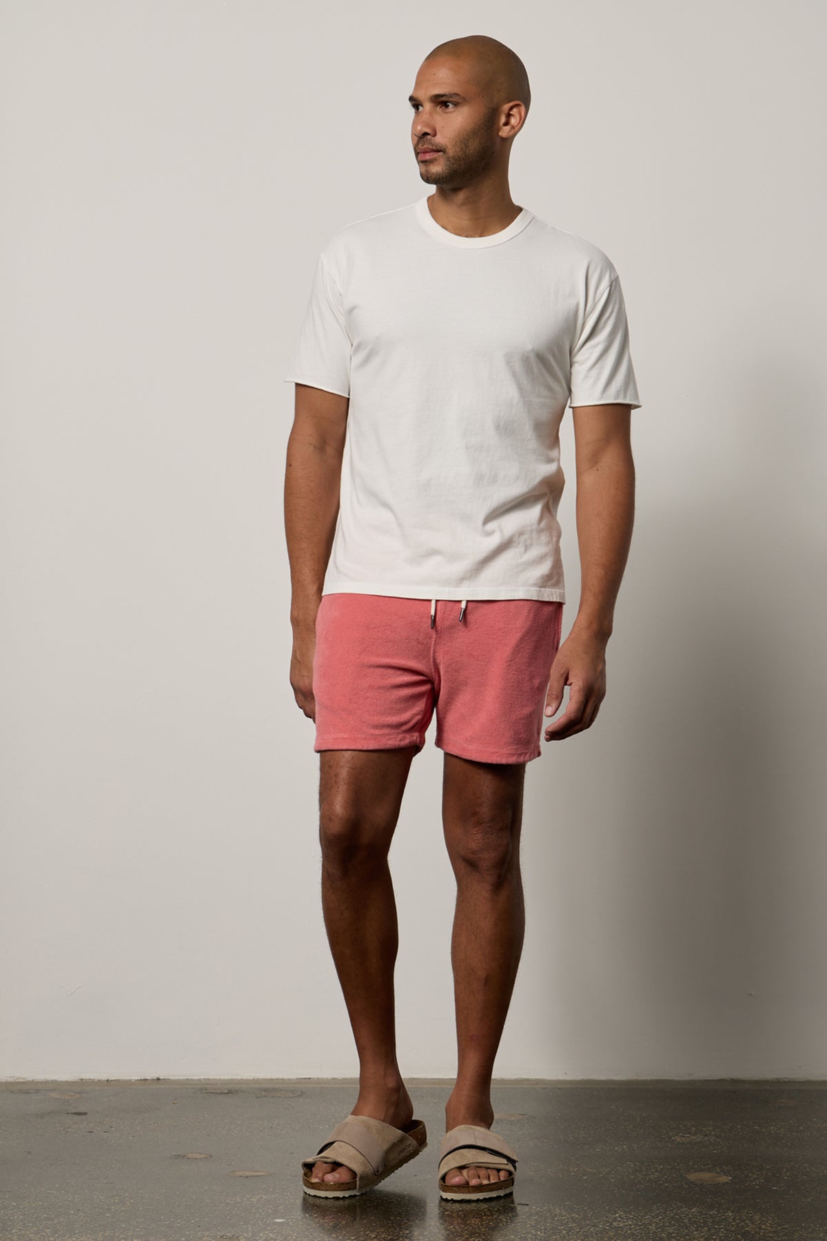   Man facing front wearing Beau Tee in salt with Ozzie Shorts in goa full length with Birkenstocks 