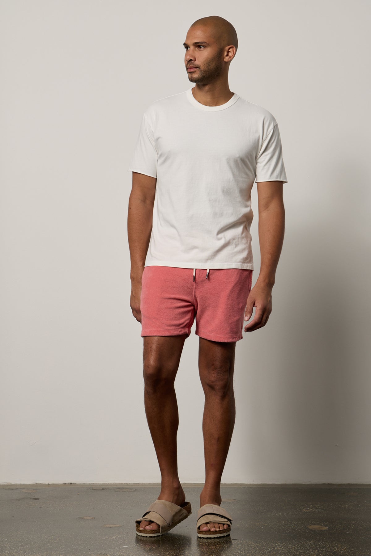 Man facing front wearing Beau Tee in salt with Ozzie Shorts in goa full length with Birkenstocks-26468396138689