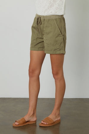 a woman wearing the Velvet by Graham & Spencer TENLEY COTTON TWILL SHORT and sandals.