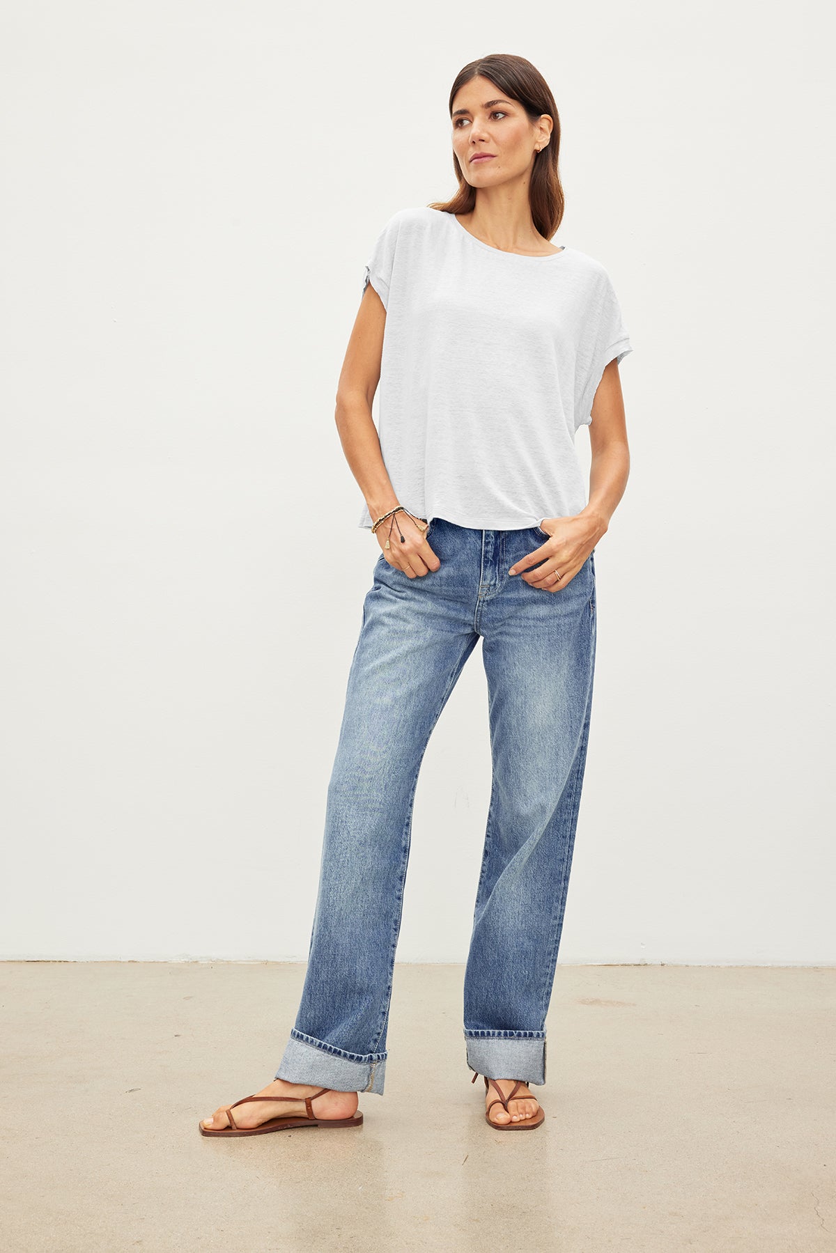   A woman wearing jeans and a Velvet by Graham & Spencer HUDSON CREW NECK TEE. 