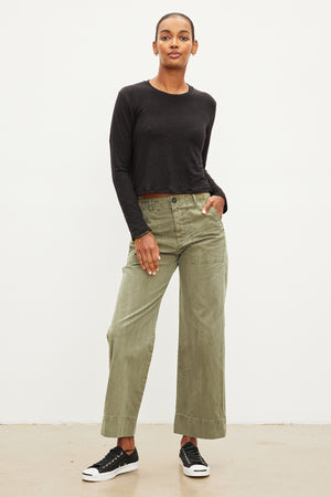 The model is wearing Velvet by Graham & Spencer lightweight linen green cropped pants.